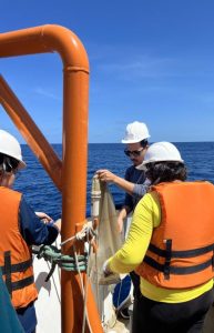 Cruise participants working with oceanographic equipment