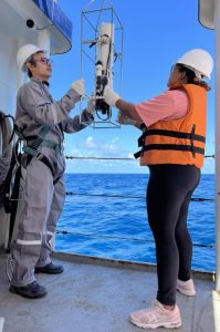 Cruise participants working with oceanographic equipment